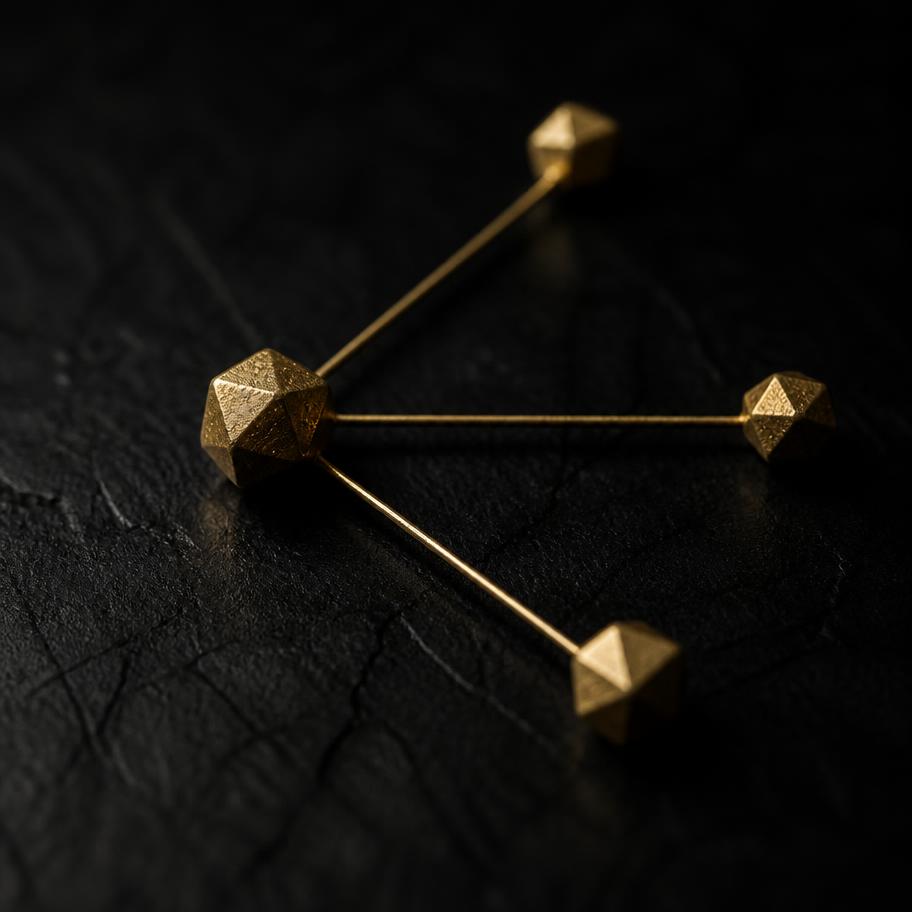 Three brass nodes branching from a single node on a black surface